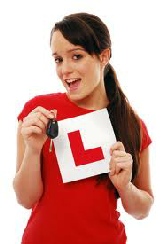 Young lady with car key saying "I Passed 1st Time"